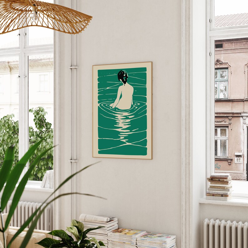 May include: A teal green and white print of a woman sitting in a pool of water. The woman has dark hair and is facing away from the viewer. The water is rippling around her.