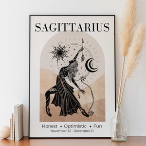 May include: Black framed Sagittarius zodiac art print. The illustration features a woman with a bow and arrow, a sun, and a crescent moon. Text includes "Sagittarius", "Honest + Optimistic + Fun", and the dates November 22 - December 21.