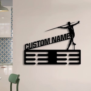 May include: Black metal medal display with a silhouette of a javelin thrower and the text "CUSTOM NAME". The display has eight slots for medals.
