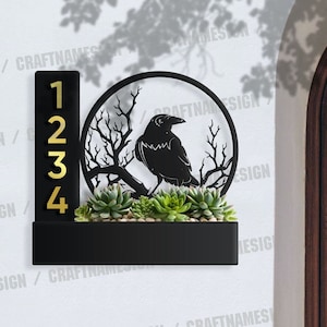 May include: Black metal house number plaque with a raven silhouette and a potted succulent plant. The numbers 1, 2, 3, and 4 are displayed in gold.