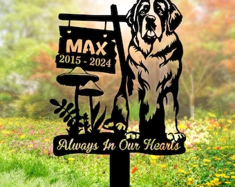 May include: Black metal silhouette of a Bernese Mountain Dog with a sign that reads "Max 2015-2024" and "Always In Our Hearts". The sign is attached to a metal stake.