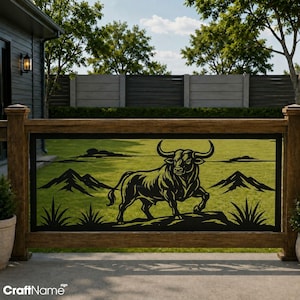 May include: A black metal decorative railing insert featuring a laser-cut silhouette of a bull standing on a rocky outcrop, flanked by mountain peaks and desert plants. The design is framed within a rectangular border, set against a green lawn.
