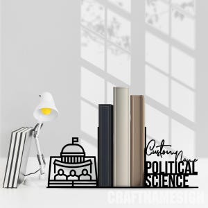 May include: Black metal bookends shaped like a building with a dome and three people standing in front of it. The bookends have the text "Custom Name Political Science" on the right side.