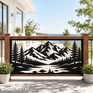 May include: A black metal decorative panel featuring a laser-cut mountain range landscape with pine trees and a lake. The design is framed within a wooden railing structure, showcasing a detailed silhouette of peaks, forest, and water.