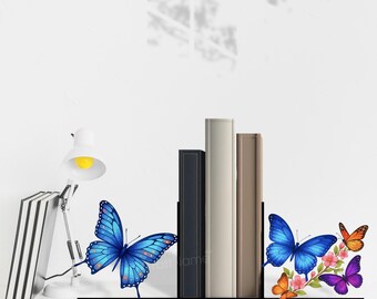 May include: A black metal bookend set featuring colorful butterfly and floral designs. One piece displays a large blue butterfly, while the other shows a blue butterfly, a purple butterfly, an orange butterfly, and pink flowers.
