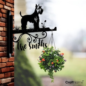 May include: Black metal silhouette of a Schnauzer dog with a hanging planter and the text "The Smiths" on a decorative house sign.