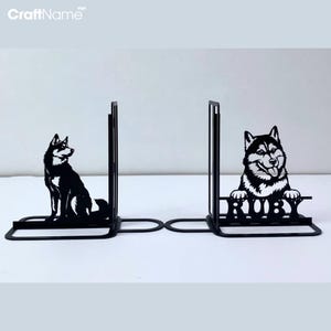 May include: Black metal bookends featuring a silhouette of a dog with the name "RUBY" on the right bookend.