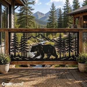May include: A black metal decorative railing panel featuring a laser-cut silhouette of a walking bear surrounded by pine trees and mountain peaks. The rectangular panel is framed by a wooden structure and displays a detailed nature-inspired scene.