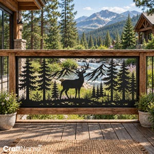 May include: A black metal railing insert featuring a laser-cut silhouette of a standing deer with antlers, surrounded by a dense forest of pine trees and jagged mountain peaks, designed to fit within a wooden deck frame structure.