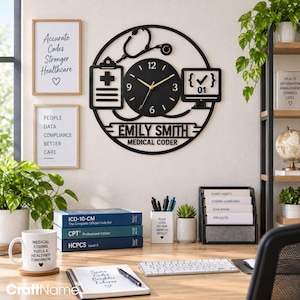 May include: A circular black wall clock featuring a stethoscope, a clipboard with a medical cross, and a computer monitor icon. The clock face displays the name EMILY SMITH and the text MEDICAL CODER in white lettering with gold clock hands.