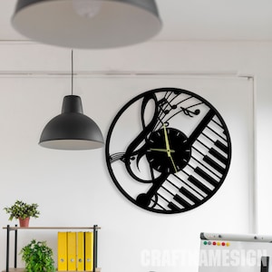 May include: Black wall clock with a treble clef and piano keys design. The clock face is black with gold hands.