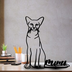 May include: Black metal silhouette of a cat sitting with its tail curled around the word "Mimi".