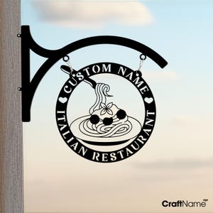 May include: Black metal Italian restaurant sign with a circular design featuring spaghetti and meatballs. The sign includes the text "CUSTOM NAME" and "ITALIAN RESTAURANT". It is suspended from a curved bracket.