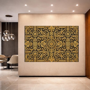 May include: Large wall art featuring a black background with an ornate gold pattern. The design includes floral and geometric elements, creating a luxurious and detailed aesthetic. The artwork is displayed in a modern interior setting.