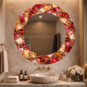 May include: A round decorative mirror with a mosaic-style border. The border features a pattern of red, orange, and yellow glass pieces set within a gold-colored frame. The mirror is mounted above a bathroom sink.
