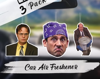 May include: Three pack of car air fresheners featuring images of a character from the TV show "The Office". The air fresheners are hanging from a rearview mirror. The text "3 Pack" and "Car Air Freshener" are visible in the image.
