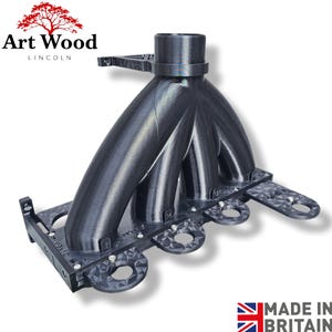 May include: A black, 3D-printed intake manifold with multiple curved tubes and mounting points. The product has a textured surface and is labeled with "Art Wood Lincoln". The image also includes the text "Made in Britain".