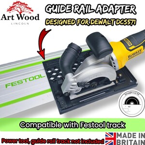 May include: A black guide rail adapter for a DeWalt DCS571 power tool, designed for use with a Festool track. The adapter features a honeycomb pattern and is shown attached to a yellow and black circular saw on a silver and green guide rail.