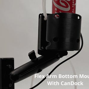 May include: A black adjustable flex arm mount featuring a cylindrical cup holder attachment, labeled Flex Arm Bottom Mount With CanDock. The device holds a red beverage can and includes a black mounting base with visible screws and a thin white tube.