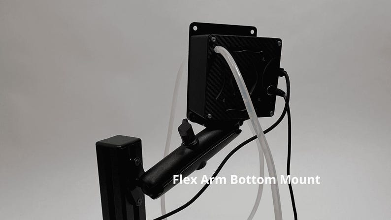 May include: A black electronic device with a carbon fiber pattern finish, mounted on an adjustable black arm. The unit features a clear tube, black cables, and a metal mounting plate. The text Flex Arm Bottom Mount is visible on the image.