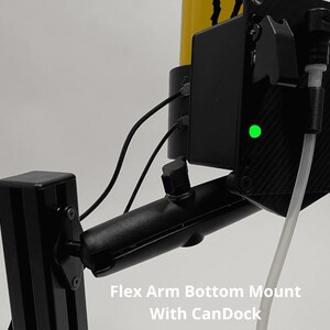 May include: A black Flex Arm Bottom Mount with CanDock featuring a yellow cylindrical component, a black rectangular housing with a glowing green LED indicator, and a clear plastic tube connected to the side. The text Flex Arm Bottom Mount With CanDock is visible.