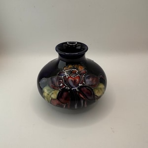 William Moorcroft vintage petite squat Columbine floral vase. Cobalt blue pottery vase with unusual purple Columbine floral motif.