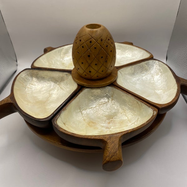 Filipino lazy Susan with capiz shell lined monkey pod wood serving dishes and pineapple centrepiece. Tiki style server.