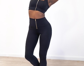 Milieuvriendelijke zwarte set sportkleding: legging met hoge taille en sport-bh met rits