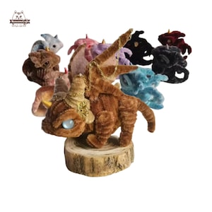 May include: A collection of colorful pipe cleaner dragons, each with a unique design and color. The dragons are made of chenille stems and have a whimsical, handmade look. The dragons are arranged in a circle, with the brown dragon in the center.