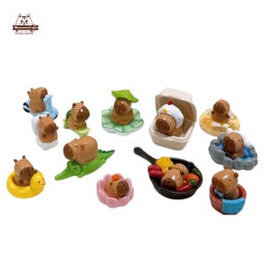 May include: A selection of miniature capybara figurines in different scenarios. Some capybaras are on a scooter, a lily pad, a crocodile, and in a frying pan with vegetables. Other capybaras are in a duck floatie, a flower, and a takeout container.