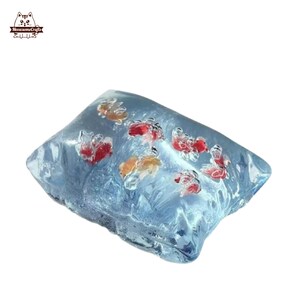 May include: A rectangular, clear resin paperweight with a blue tint, featuring several small, detailed goldfish in shades of red and orange. The goldfish appear to be suspended within the resin, creating a unique decorative item.
