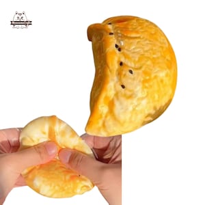 Può includere: Due giocattoli morbidi gialli e arancioni a forma di mezzaluna. I giocattoli sono realizzati con un materiale morbido e flessibile e hanno una texture realistica.
