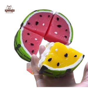 May include: A close-up of a watermelon-themed soap set. The set includes four pink and green watermelon slices and one yellow watermelon slice with white cream. The soap has black seeds and is designed to look like a slice of watermelon.