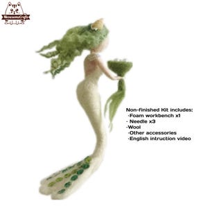 May include: A white felt mermaid doll with green hair and a crown. The mermaid is holding a bouquet of green felt flowers. The doll is part of a craft kit that includes a foam workbench, needles, wool, other accessories, and an English instruction video.