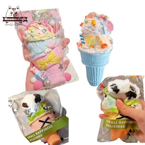 May include: Three colourful ice cream cone shaped squishy toys in individual plastic bags. The ice cream cones are decorated with sprinkles, candy, and other toppings. The bags have the text "Small Happiness Delicious" printed on them.