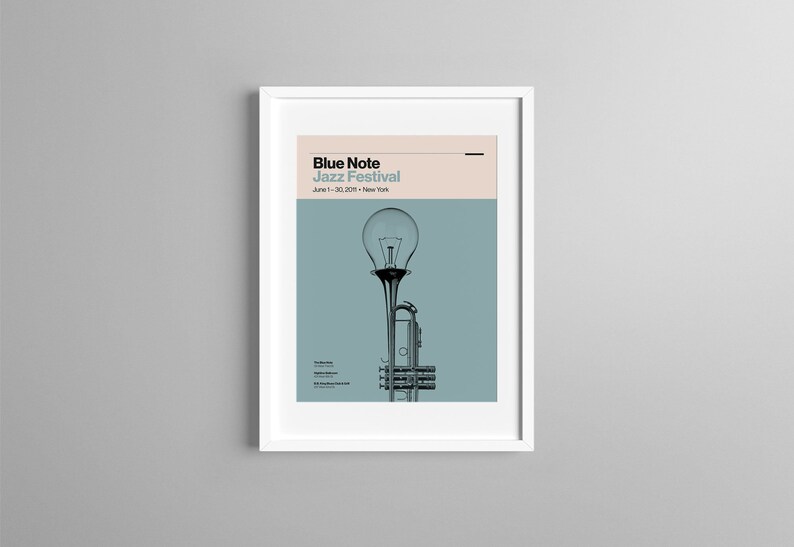 May include: A poster for the Blue Note Jazz Festival in New York City, June 1-30, 2021. The poster features a light blue background with a black and white illustration of a trumpet with a light bulb on top.