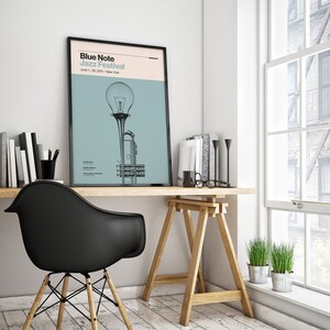 May include: A black and white poster with the text "Blue Note Jazz Festival" and the dates "June 1-30, 2011 - New York". The poster features a stylized illustration of a trumpet with a light bulb on top.