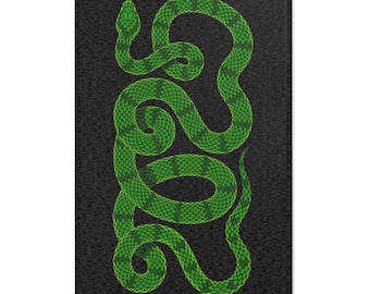 May include: A green snake with a scaly pattern is coiled on a black background. The snake is in a vertical position, with its head at the top and its tail at the bottom.