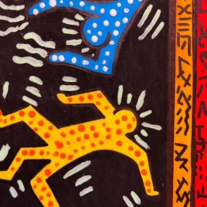 May include: Abstract artwork featuring figures in yellow and blue with red polka dots on a black background. The artwork includes white accents and a signature in the bottom right corner. The style is reminiscent of pop art.