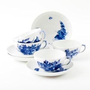 May include: Set of four blue and white porcelain teacups and saucers with floral designs.