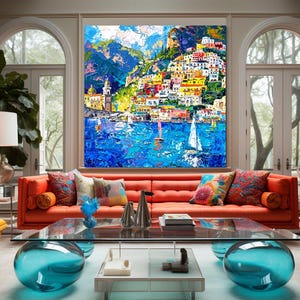May include: A colorful painting of a seaside town with buildings on a hillside, boats in the water, and a blue sky with clouds. The painting is framed and hanging on a wall in a living room.