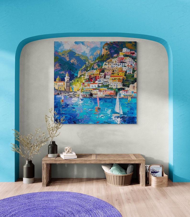 May include: A colorful painting of a seaside town with colorful buildings on a hillside, boats in the water, and a blue sky with clouds.