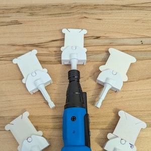 May include: A blue and black NEIKO torch lighter with five white plastic attachments. The lighter has a blue rubber grip and the brand name is printed in white. The attachments are arranged around the lighter.