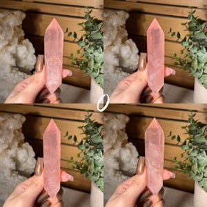 May include: Four images of a pink rose quartz crystal point. The crystals are held in front of a wooden background with green plants and a white geode. The crystals are a light pink color and have a pointed tip.