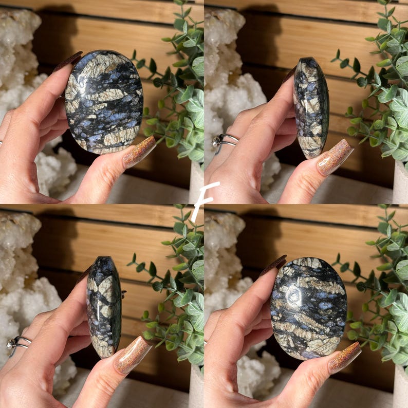 May include: Four views of a polished oval stone. The stone features a mix of blue, gray, and white patterns. The stone is held in a hand, with a wooden background and greenery in the background.