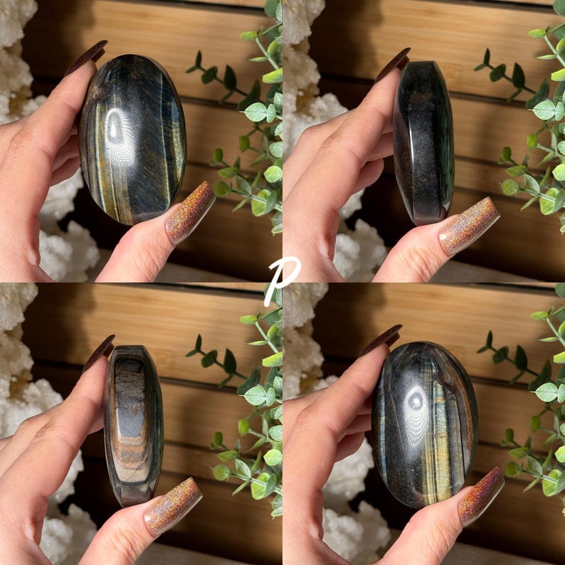 May include: Four images of a polished, oval-shaped stone. The stone has a mix of dark blue, gold, and brown colors. The stone is held in a hand, and the background includes greenery and a wooden surface.