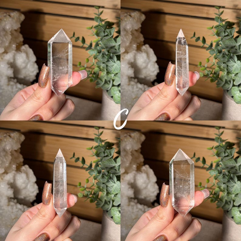 May include: Four clear quartz crystal points, each held up in front of a background of greenery and a wooden surface. The crystals are transparent with visible internal structures. The letter "C" is written in white in the center of the image.