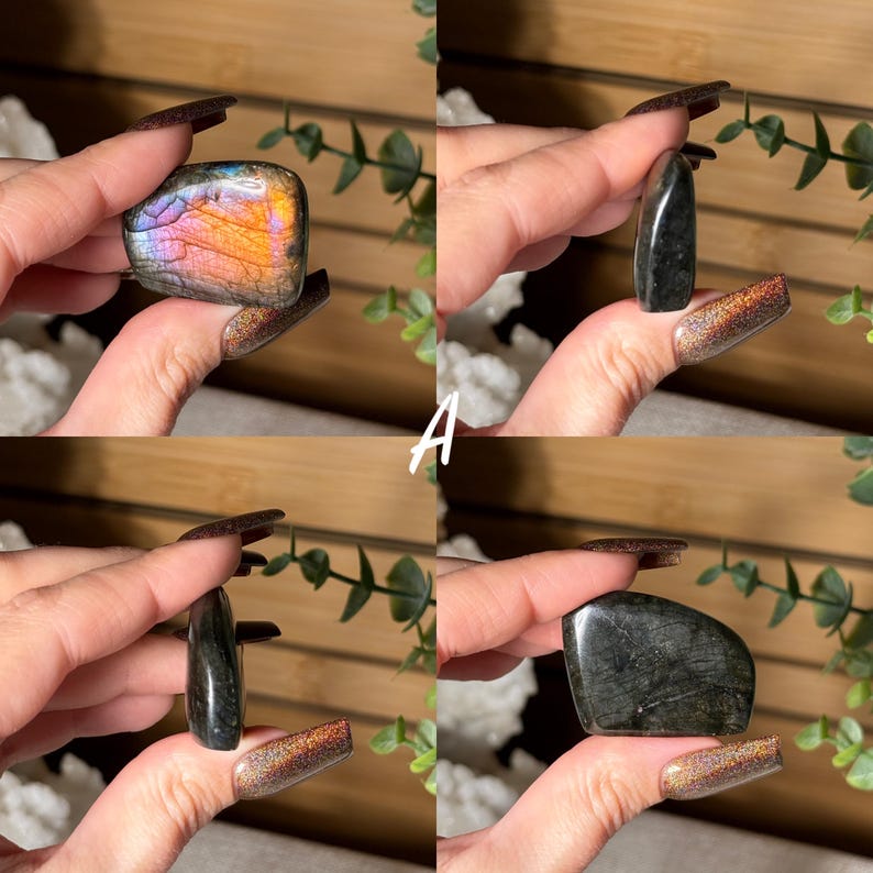 May include: Four polished gemstone specimens are displayed. One is a rectangular shape with iridescent orange, pink, and purple hues. The other three are dark, with a polished, reflective surface. The letter "A" is visible in the image.