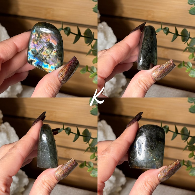 May include: Four polished labradorite stones in various shapes are displayed. The stones exhibit a range of colors, including blues, greens, and purples, with iridescent flashes. The stones are held in hands, showcasing their natural beauty and unique patterns.