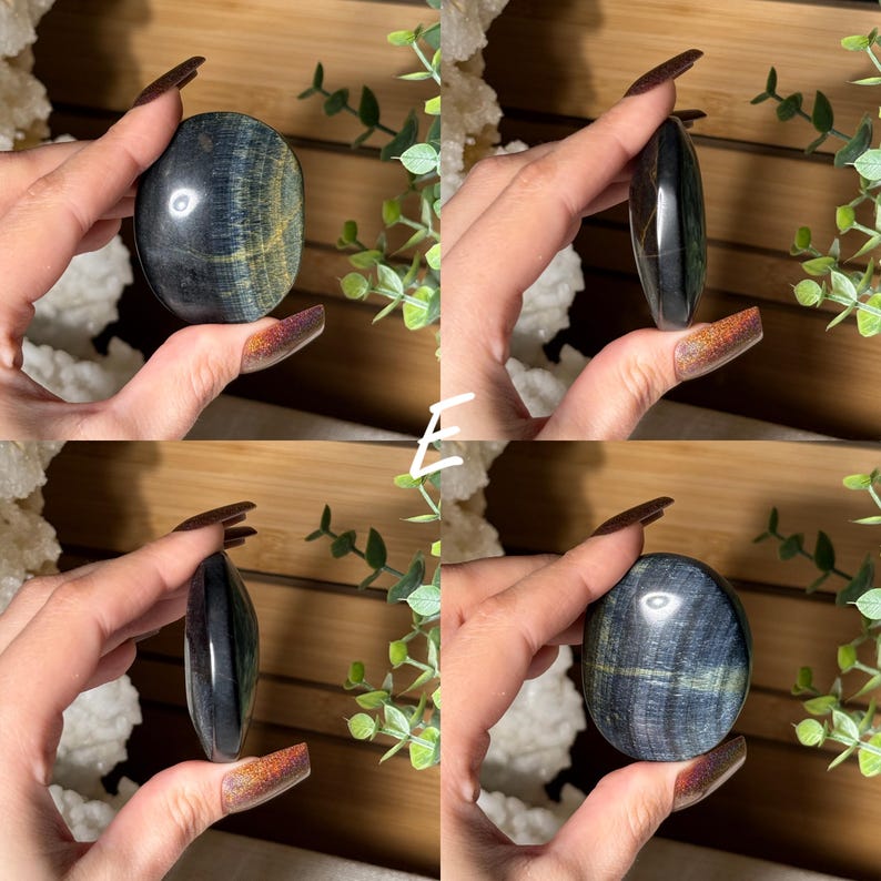 May include: Four views of a polished blue tiger's eye stone. The stone has a dark blue base color with golden-yellow and green chatoyancy. The stone is oval-shaped and held in a hand.